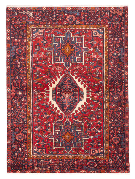 Decorative red rug with intricate patterns on a plain background